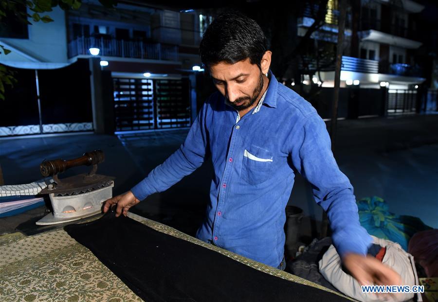 INDIA-NEW DELHI-CLOTHES-IRONING STAND