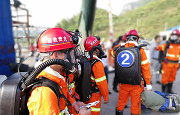 China tunnel blast injures 12, traps 12